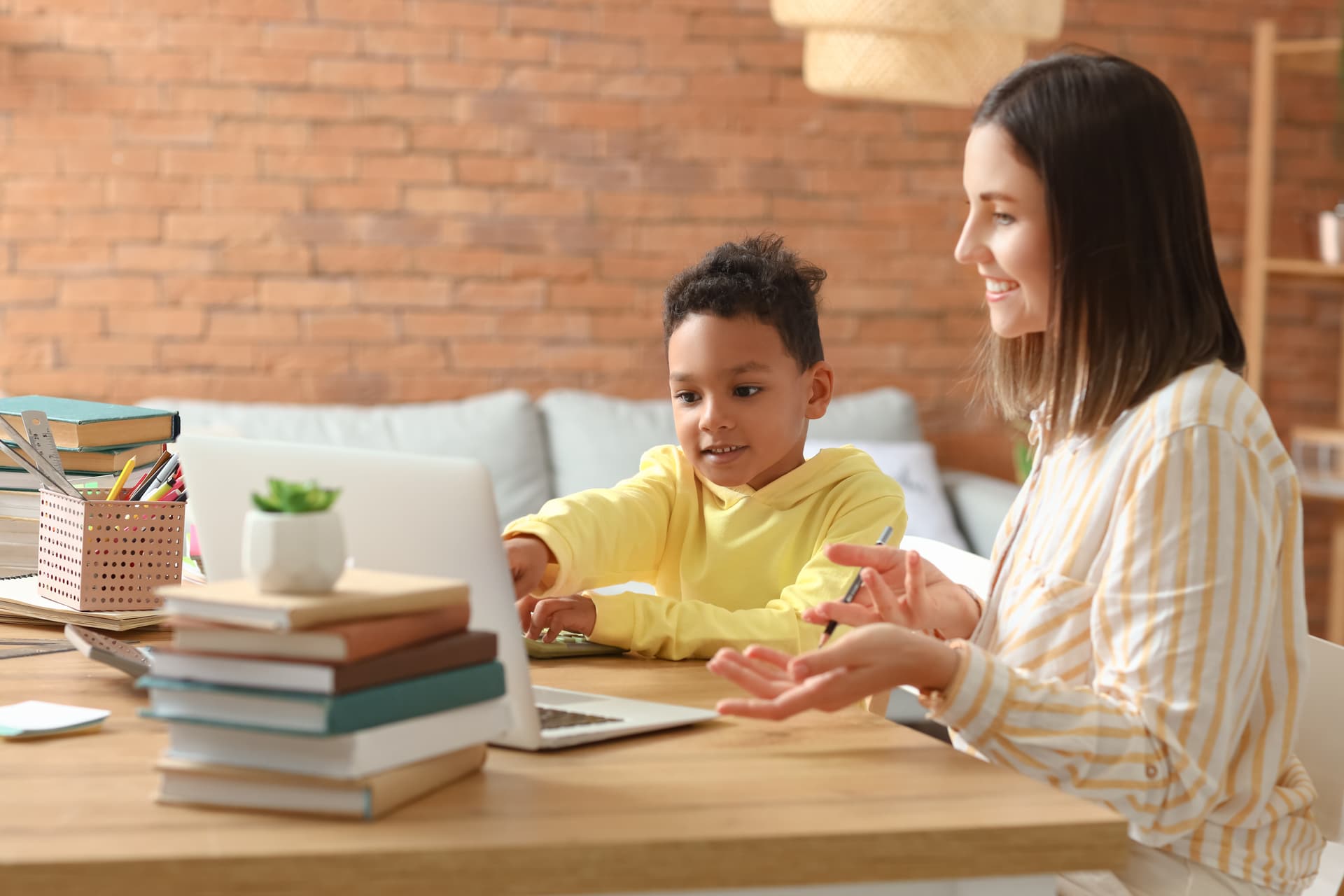 Child receiving one-on-one reading support from qualified tutor using specialist intervention methods