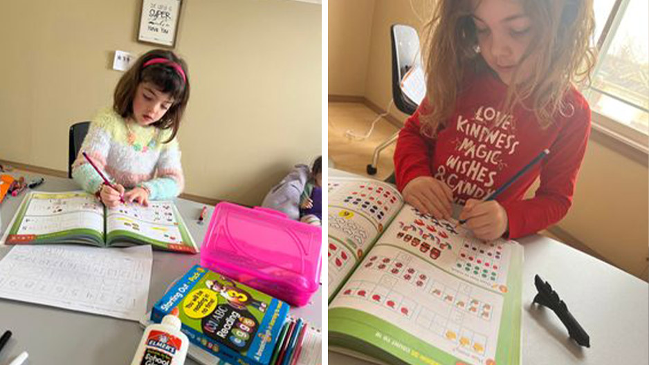 Homeschooled Kindergarten girl learning with Reading Eggs workbooks.