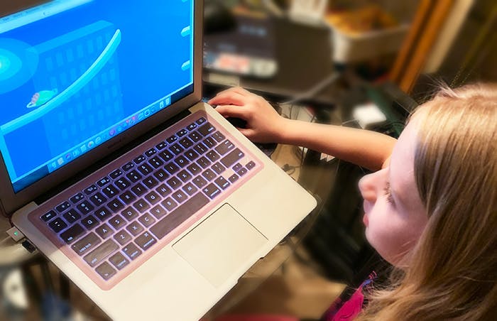 Six year old girl learning with Reading Eggs online program.