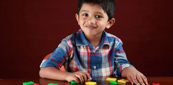 Image of boy phonics with alphabet letters