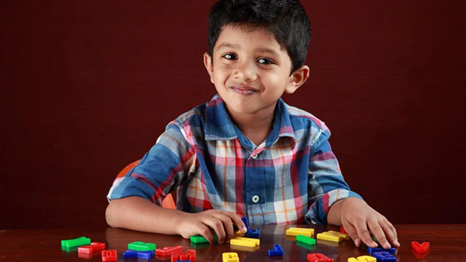 Image of boy phonics with alphabet letters